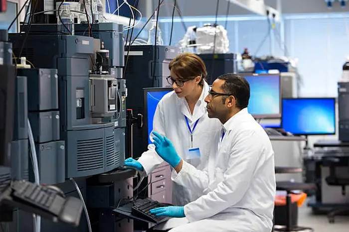 Scientists operating analytical instruments